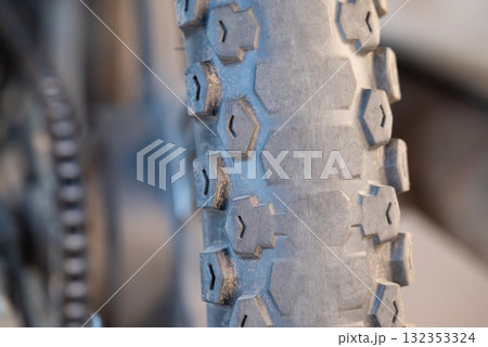 Worn out rear tire of motorbike. Old rubber tire on bike have to be changed to drive 132353324