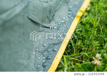 Tent in water drops. Close up of rain or fog water drops on tent in the morning, rainy weather 132353344