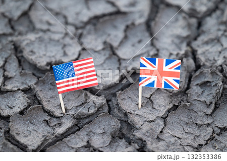 Flag of USA and Great Britain on cracked soil. Symbol of problems in relations between two countries USA and Great Britain, political and trade crisis 132353386