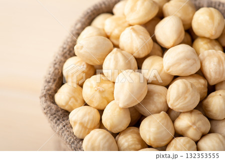 Close up of peeled hazelnuts in linen bag. Fresh tasty hazelnuts in sack 132353555