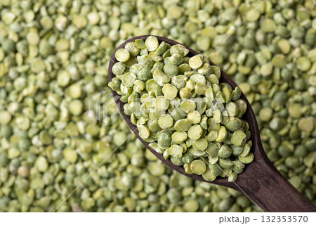 Background of green pea in dark wooden spoon. Green dry pea background, cooking with pea Background of green pea in dark wooden spoon. Green dry pea background, cooking with pea 132353570
