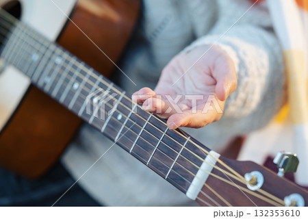 Girl shows callus on her fingers after playing the guitar for a long time. Close up of young female guitaris practicing instrument on nature on a cool sunny weather Girl shows callus on her fingers after playing the guitar for a long time. Close up of young female guitaris practicing instrument on nature on a cool sunny weather 132353610