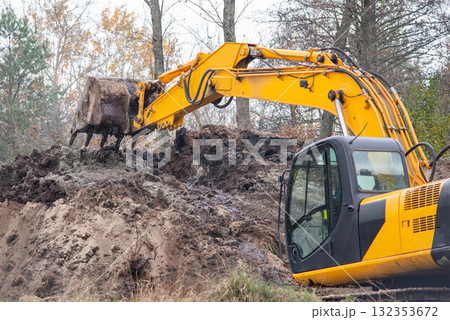 Excavator digging soil. Construction work in countryside, digging soil Excavator digging soil. Construction work in countryside, digging soil 132353672
