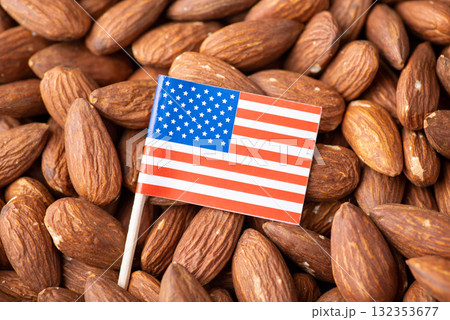 Small flag of USA on almond nuts. Trade of nuts concept, origin of almond Small flag of USA on almond nuts. Trade of nuts concept, origin of almond 132353677