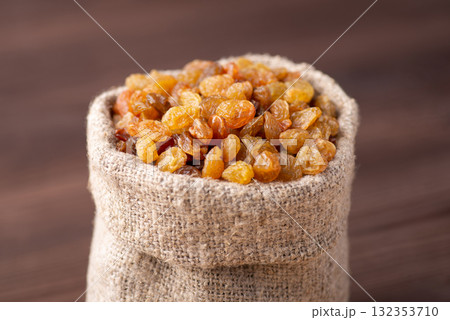 Small fancy bag full of raisins. Tasty raisins made of high quality grapes Small fancy bag full of raisins. Tasty raisins made of high quality grapes 132353710