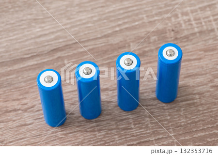 4 pieces of 18650 lithium-ion batteries on the table. Modern high capacity batteries close up 4 pieces of 18650 lithium-ion batteries on the table. Modern high capacity batteries close up 132353716