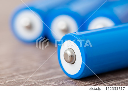 Close up of blue 18650 batteries on the table. Rechargeable li-ion batteries ready for use Close up of blue 18650 batteries on the table. Rechargeable li-ion batteries ready for use 132353717