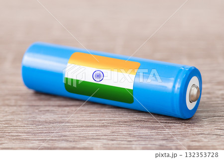 Rechargeable battery with flag of India on table. Origin of battery, produce accumulators in India 132353728