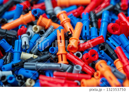 Close up on colourful engineering constructor parts on the table. Background of plastic parts of developing constructor for small engineers Close up on colourful engineering constructor parts on the table. Background of plastic parts of developing constructor for small engineers 132353750