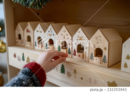 A hand of kid open wooden advent calendar for a Christmas A hand of kid open wooden advent calendar for a Christmas 132353943