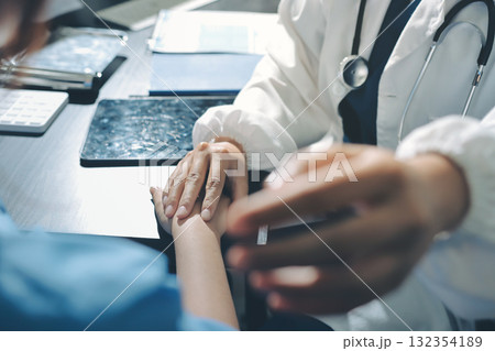 Male doctors shake hands with patients encouraging each other and praying for blessings. To offer love, concern, and encouragement while checking the patient's health. concept of medicine 132354189