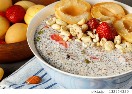 Bowl of chia poudding with pieces of apricots and strawberry 132354329