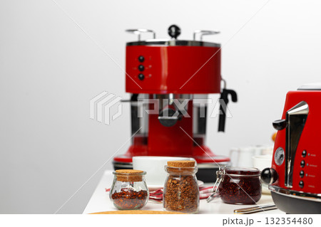 Close up of red kitchen .appliances on kitchen table Close up of red kitchen .appliances on kitchen table 132354480