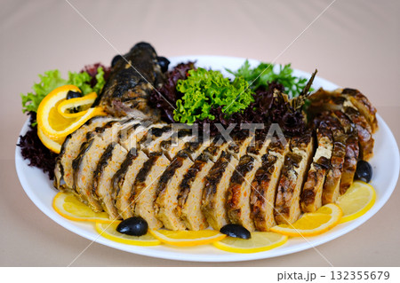 Herb-stuffed trout with tomatoes and green salad Herb-stuffed trout with tomatoes and green salad 132355679