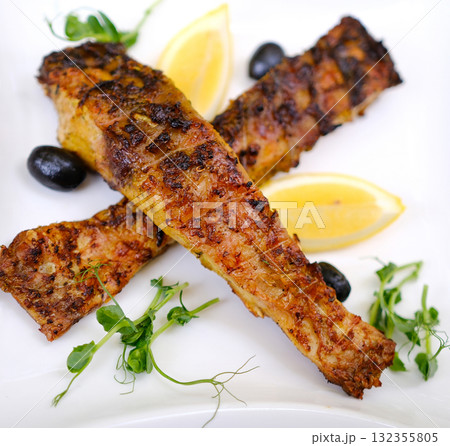 Grilled fish lemon Korean BBQ squid calamary and ingredients on dark background. Traditional korean dish - grilled squid stuffed with onion and tomatoes. Top view. 132355805