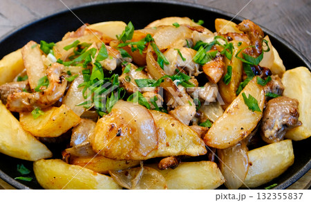 Potatoes mushrooms herbs Oven baked potatoes with mushrooms and rosemary on rustic white wooden table, selective focus 132355837