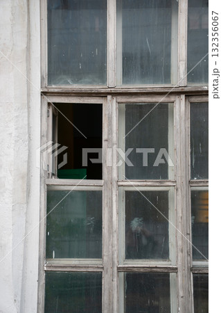 Old wooden window with peeling paint and slightly open sash in the locomotive museum Povorotny Krug 132356067
