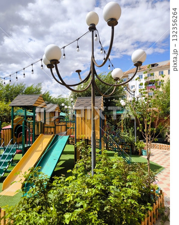 Children's playground with slides and wooden houses in the open air 132356264