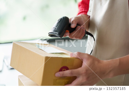 Inventory management with employee scanning packages using barcode scanner 132357185