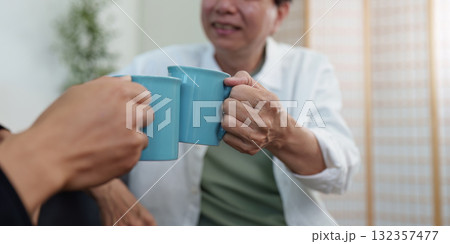 Hobby family sharing a toast with coffee mugs 132357477
