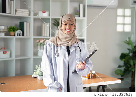 Healthcare Professional and Patient Care. A confident female doctor poses with a clipboard, ready to assist her patients. Healthcare Professional and Patient Care. A confident female doctor poses with a clipboard, ready to assist her patients. 132357615