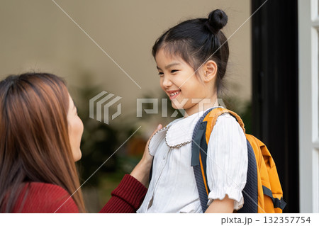 Confidence Boost Before School. A girl smiles brightly at a woman who supports her for the school journey ahead. Confidence Boost Before School. A girl smiles brightly at a woman who supports her for the school journey ahead. 132357754