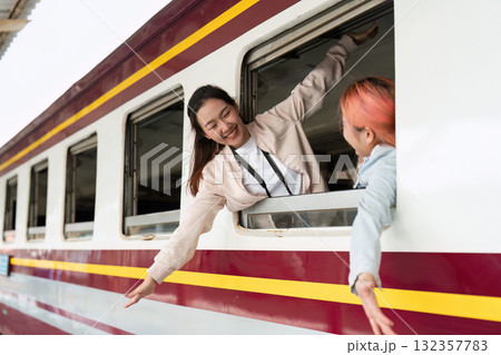 Friendship and Connection. Two friends joyfully greet each other from the train windows, celebrating their reunion. 132357783