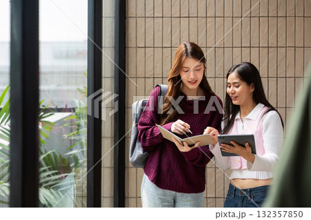 Study Collaboration and Engagement. Friends discussing their coursework while exploring resources together. 132357850