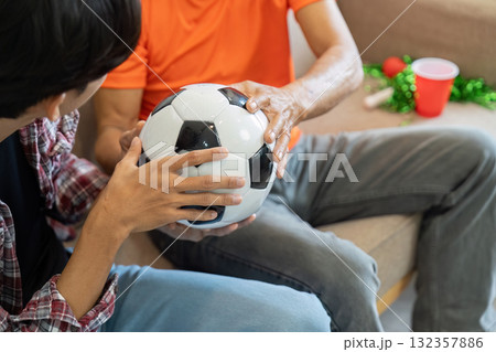 Sports and Togetherness. Two males sharing a soccer ball during a casual moment. Sports and Togetherness. Two males sharing a soccer ball during a casual moment. 132357886
