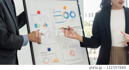Data Presentation and Business Collaboration. Team members analyze financial reports during a key planning session. 132357889