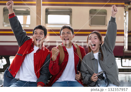 Excitement and Travel. A group of friends celebrating their upcoming journey at the train station. Excitement and Travel. A group of friends celebrating their upcoming journey at the train station. 132357957