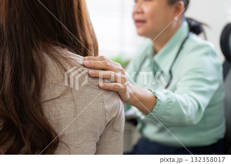 Empathy and Support in Healthcare. A doctor shows compassion by comforting a patient during a medical consultation. 132358017