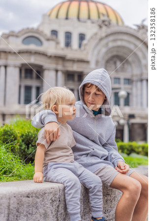 Two young boy tourists in front of Palacio de Bellas Artes in Mexico City, enjoying sightseeing, travel adventure, and cultural exploration. Childhood travel and tourism concept Two young boy tourists in front of Palacio de Bellas Artes in Mexico City, enjoying sightseeing, travel adventure, and cultural exploration. Childhood travel and tourism concept 132358186