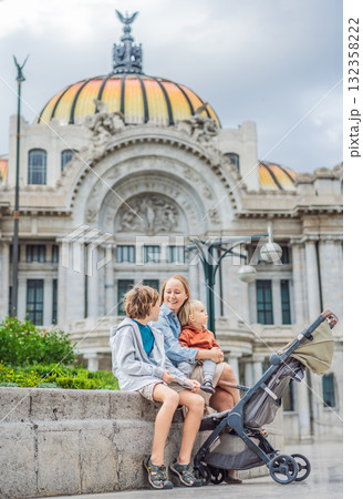 Mother tourist with her two sons in front of Palacio de Bellas Artes in Mexico City, enjoying family travel, architecture, and cultural heritage. Family travel and bonding concept 132358222