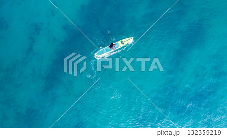 People practicing paddleboarding on the sea People practicing paddleboarding on the sea 132359219