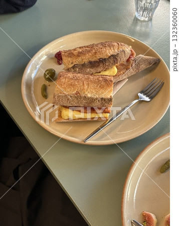 Crispy baguette sandwich filled with fresh vegetables, savory meat, and creamy dressing. A perfect balance of crunch and flavor in every hearty and satisfying bite. 132360060