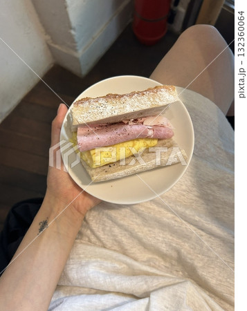 Delicious sandwich filled with fresh ingredients like crisp vegetables, tender meats, and savory spreads, all between two slices of soft bread. Perfect for a quick and satisfying meal. 132360064