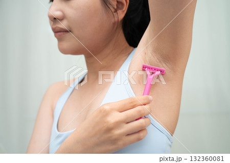 Asian young woman shaving armpit hair clean removal with razor after shower. Asian young woman shaving armpit hair clean removal with razor after shower. 132360081