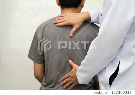 Physical therapy, Asian therapist doctor treat perform pain young man in hospital. Physical therapy, Asian therapist doctor treat perform pain young man in hospital. 132360338
