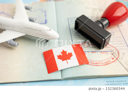 Canada flag and passport with airplane for travel. Canada flag and passport with airplane for travel. 132360344