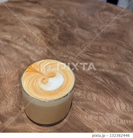 A beautifully crafted latte, featuring creamy foam art on top of rich espresso. Perfect for coffee-related projects, this image captures the warmth and inviting nature of a classic cafE experience. A beautifully crafted latte, featuring creamy foam art on top of rich espresso. Perfect for coffee-related projects, this image captures the warmth and inviting nature of a classic cafE experience. 132362446