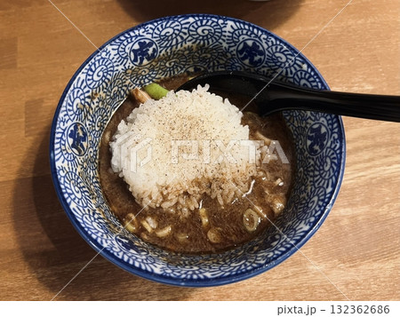 A steaming bowl of ramen with rich broth, tender noodles, sliced pork, boiled egg, nori, and fresh green onions. A comforting and flavorful Japanese classic. 132362686