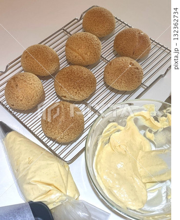 Light and airy choux pastry with a golden crust, filled with rich cream or custard. This elegant and versatile dessert offers a perfect balance of texture and sweetness. 132362734