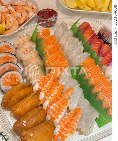 An assortment of fresh sushi, artfully arranged with a variety of toppings and vibrant colors. This traditional Japanese dish combines vinegared rice, seafood, and vegetables for an experience. An assortment of fresh sushi, artfully arranged with a variety of toppings and vibrant colors. This traditional Japanese dish combines vinegared rice, seafood, and vegetables for an experience. 132364008