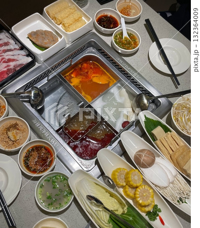 A bubbling hotpot with rich broth, tender meats, fresh vegetables, and noodles simmered to perfection. Ideal for a communal meal bursting with bold, hearty flavors. 132364009