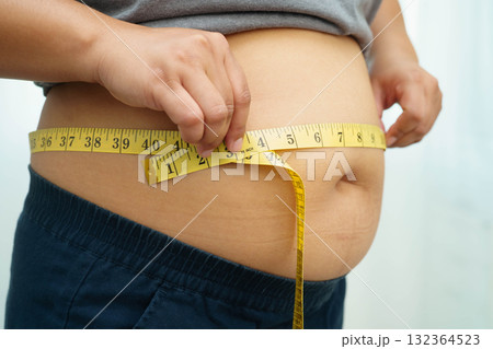 Asian woman with fat belly big size overweight and obesity with measure tape. Asian woman with fat belly big size overweight and obesity with measure tape. 132364523