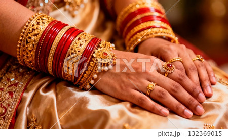 Indian Bride's Hands with Intricate Gold Jewelry and Red Bangles Indian Bride's Hands with Intricate Gold Jewelry and Red Bangles 132369015