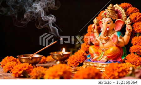 Ganesha Statue with Marigold Flowers and Incense Smoke 132369064