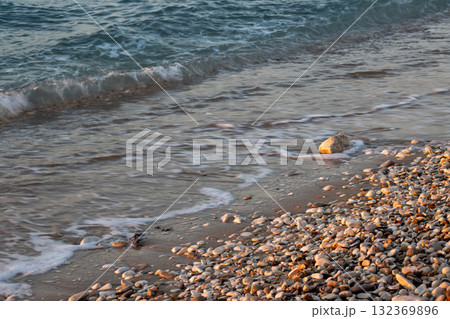 Pebbles and sea detail in the sunset, Greece Pebbles and sea detail in the sunset, Greece 132369896