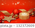 Christmas baubles decorations on a red background with copy space, focus on the foreground 132372609